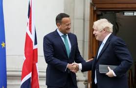 Leo Varadkar and Boris Johnson shaking hands beside a Union Jack